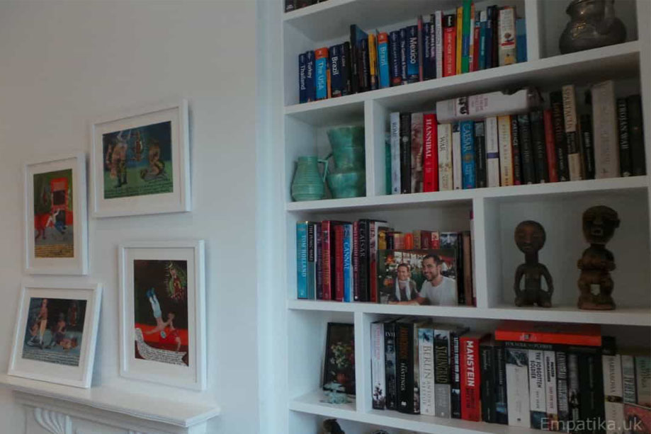 Closer look at fitted alcove bookcases with asymmetrical shelves all painted White