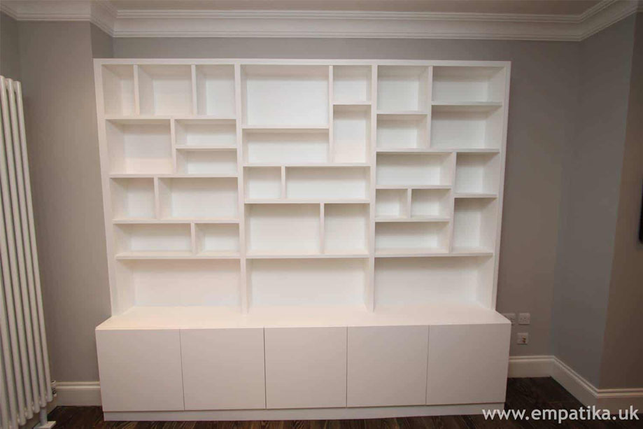 Bespoke shelving unit with random shelves and cupboards below