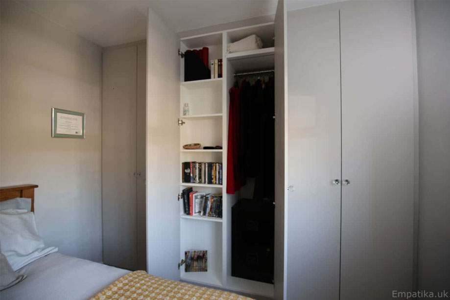 Bedroom with bespoke White painted eco-fitted wardrobes and Tree Certifcate on the wall