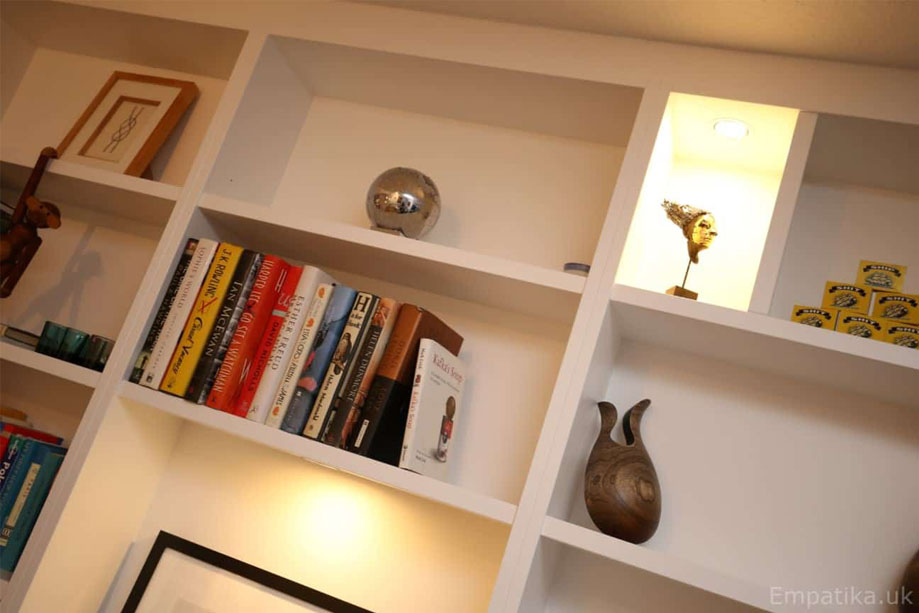 Melamine coated display unit shelves painted White with random LED lights and artworks