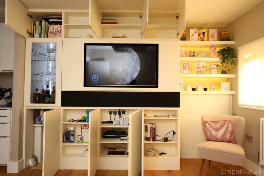 Custom made media unit with all doors open showing spacious storage shelves inside all cupboards and wine storage cupboard with lights