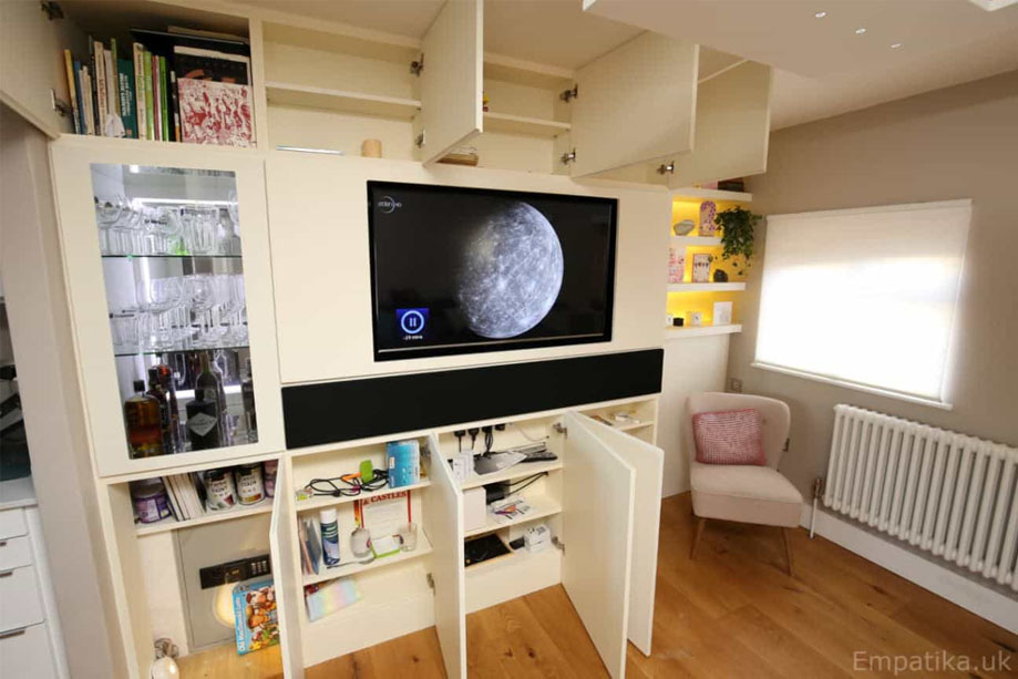 Side view of large living room TV media unit with with wine cabinet, all doors open showing interior storage shelves