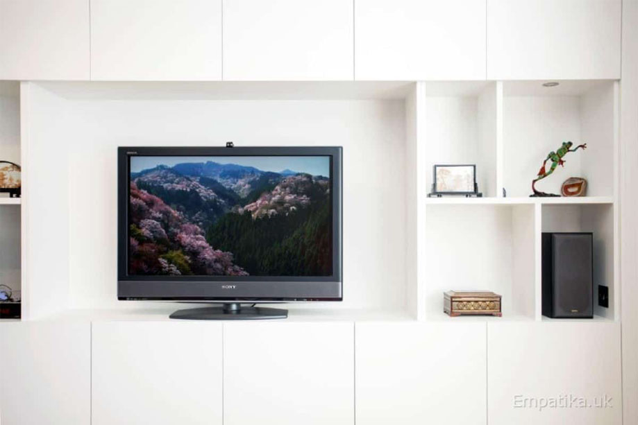 Built in tall media unit with center TV stand and asymmetrical square shelves
