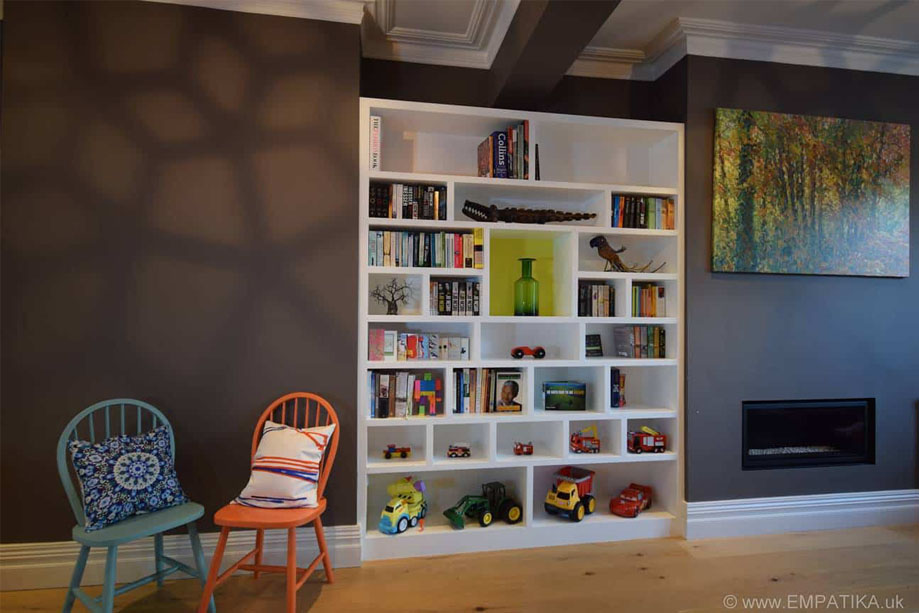 Upcycled chairs with hand made organic cusshions next to custom made shelving in living room