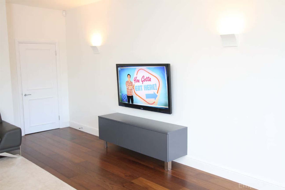 Custom built-in media unit painted Gray with 3 square doors