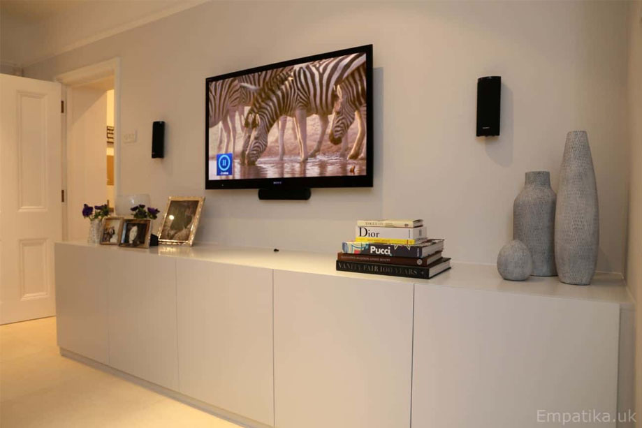 Right side view of fitted media unit with 5 closet doors all painted White