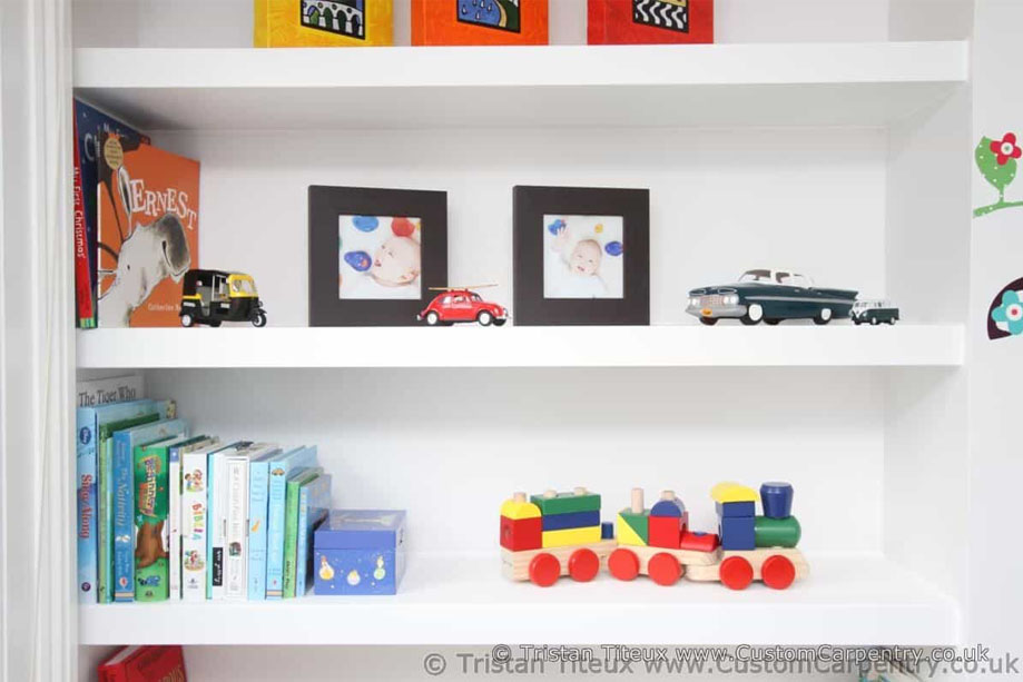 Close up of handpainted children's bedroom wall recessed shelves for toys, books, and decor