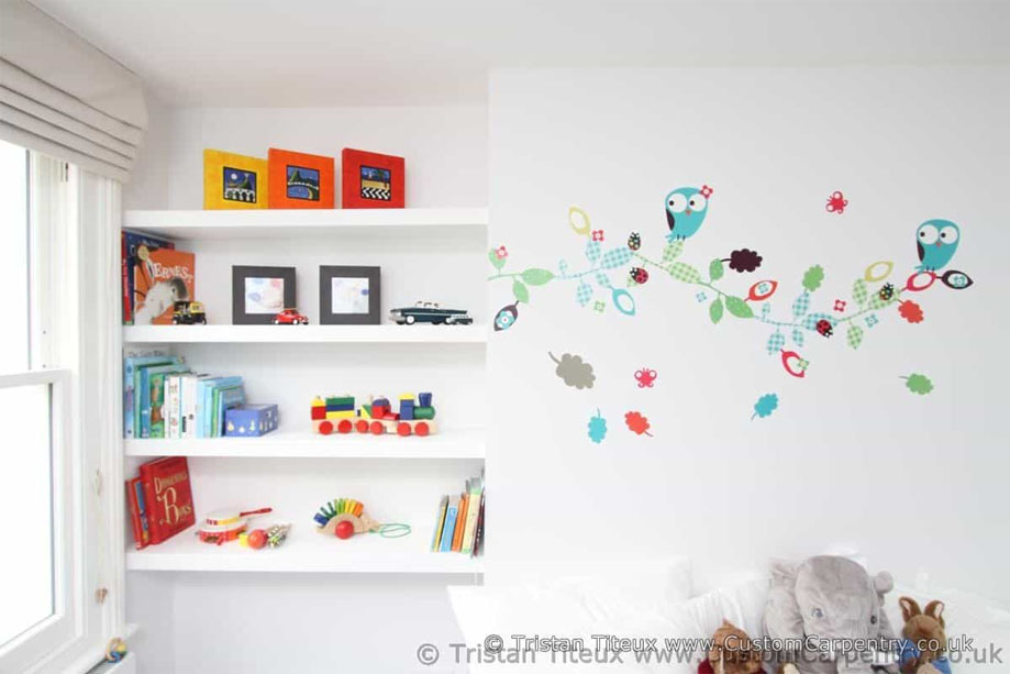 Fitted White painted wall recessed shelving by the window