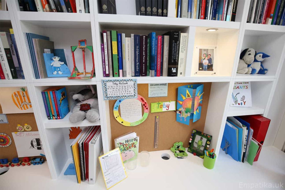 Close up of White painted library bookcase with accent LED light shelf and spacious desk