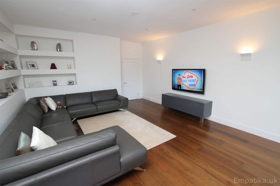 Built-in media unit painted Gray inside a living room with matching Gray sofa
