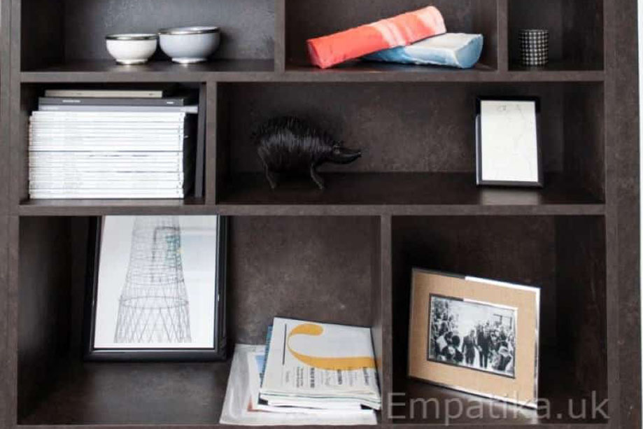 Ceiling high fitted display unit with asymmetrical shelves with accent LED lights