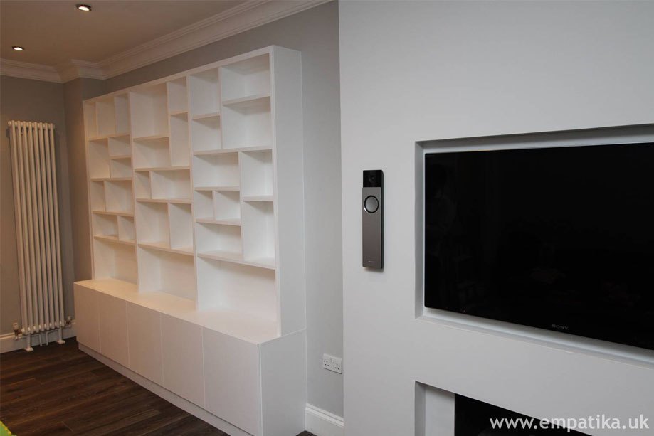 Built in shelving with storage cupboards below, hand painted white