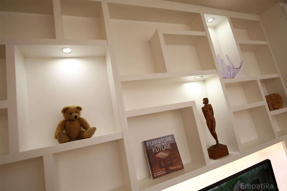 Bespoke asymmetrical shelving with ambient LED lights on White painted display unit