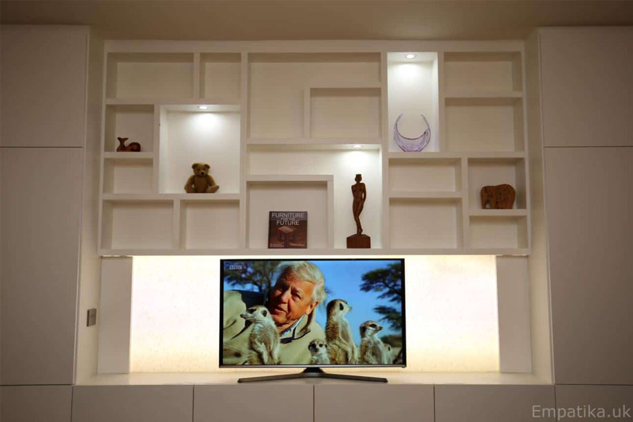 Front view of floor to ceiling eco-fitted media unit with LED light shelves and LED panel TV stand
