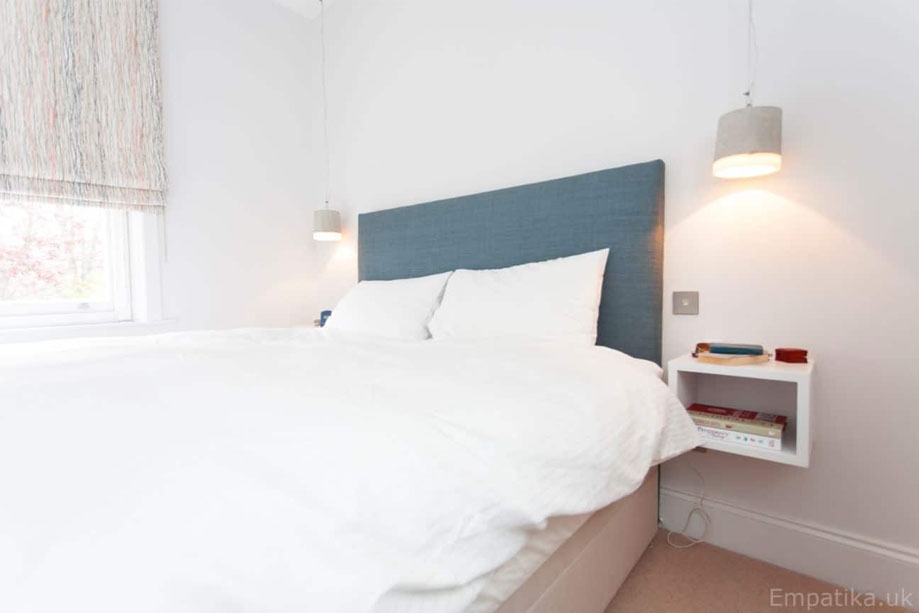 Simple White painted open square shelf on the bedside