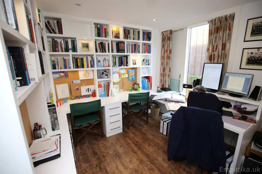 View of room with fitted home office furniture with library bookcase and 2 desks with bottom drawers all painted White