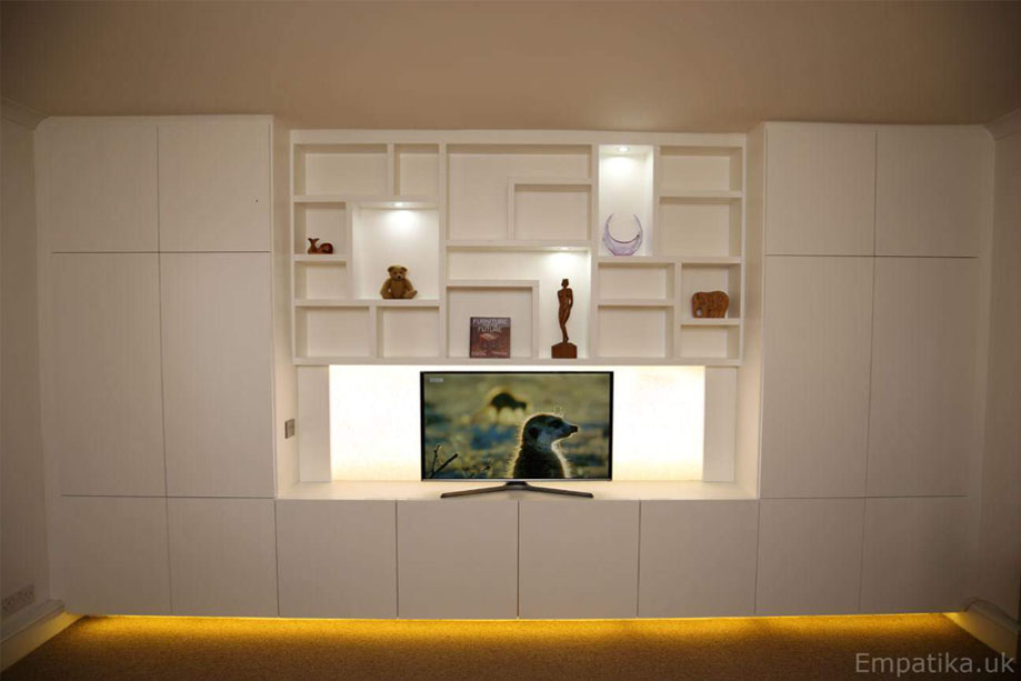 Full view of bespoke wall to wall fitted display unit with LED panel TV stand and furniture underglow