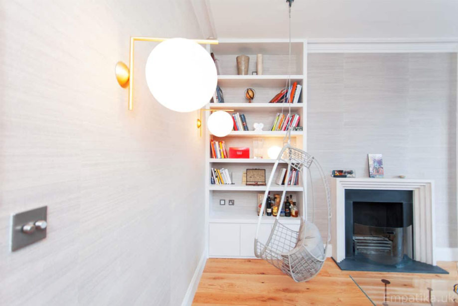 Custom fitted White painted media unit with closets and ceiling high shelves
