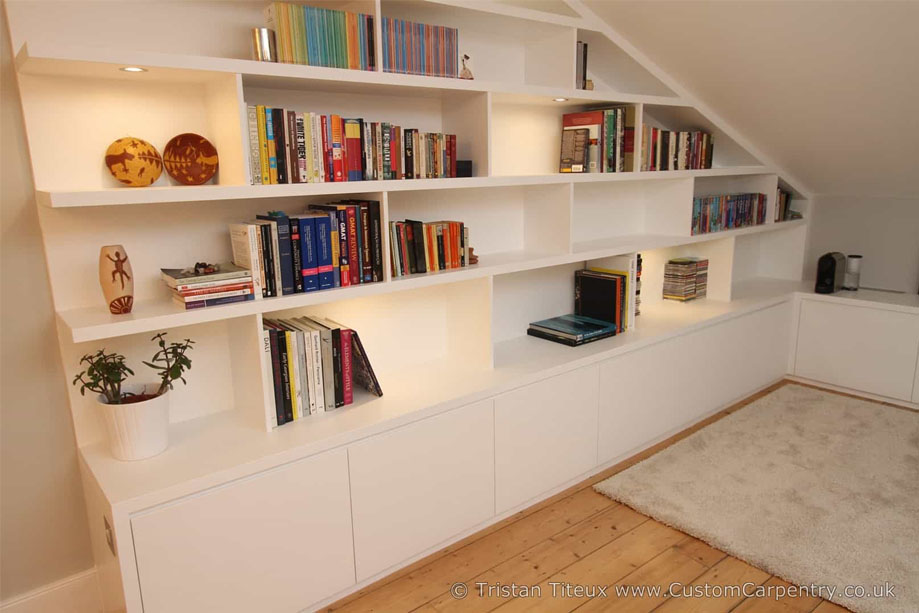 White painted bookcase with asymmetrical shelves with random LED lights and bottom closets