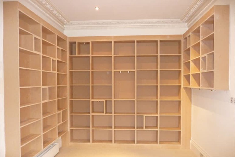 Tall fitted library bookcase built on 3 walls before it was handpainted White