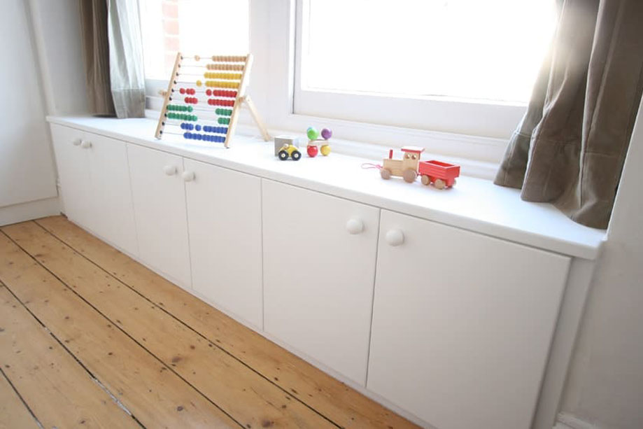 Children's bedroom low cupboards with round handles all painted White