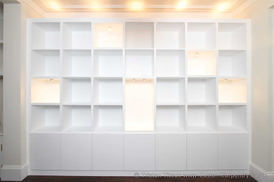Modern wall to wall library bookcase with accent LED light shelves and top ambient lighting