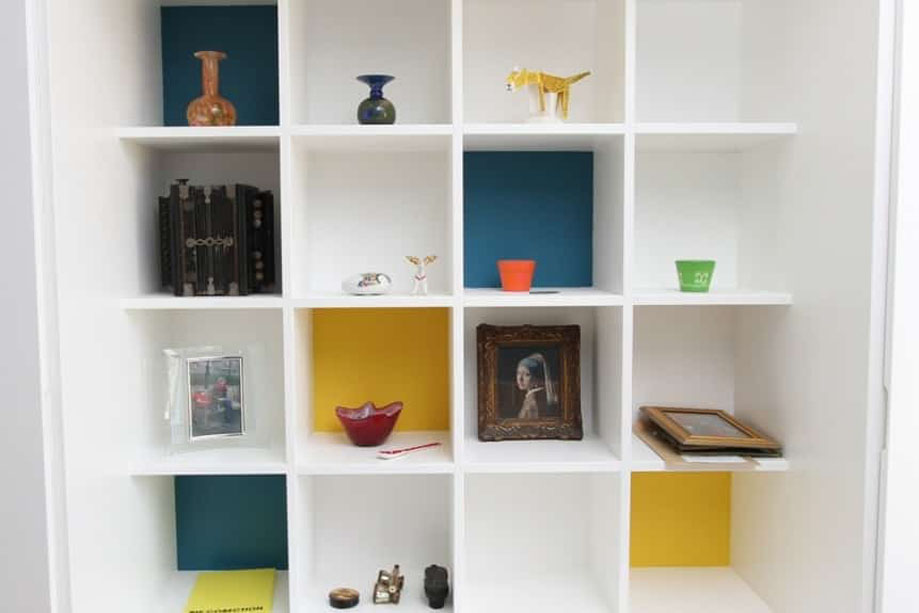 Bespoke display unit painted White with coloured square open shelves in the center