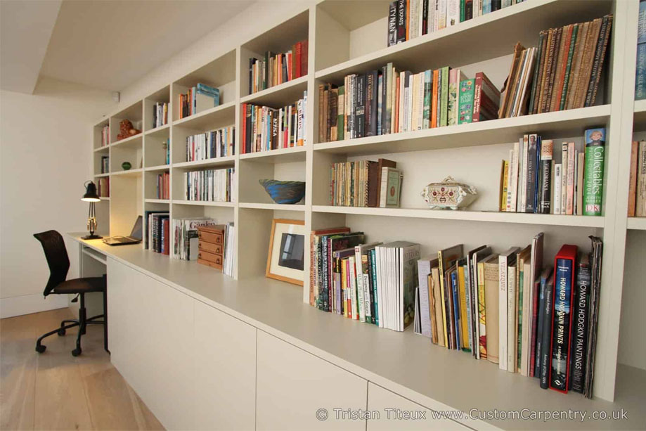 Large wall to wall fitted home office furniture with bookcase and corner computer desk with pull-out keyboard tray