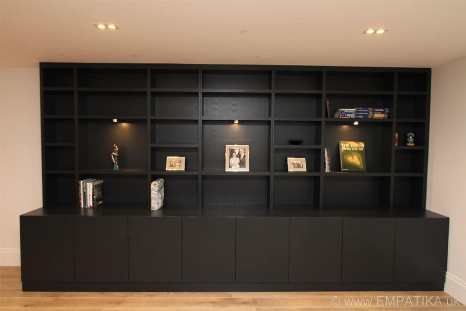 Stylish floor to ceiling display unit with open upper shelves bottom closets all painted black