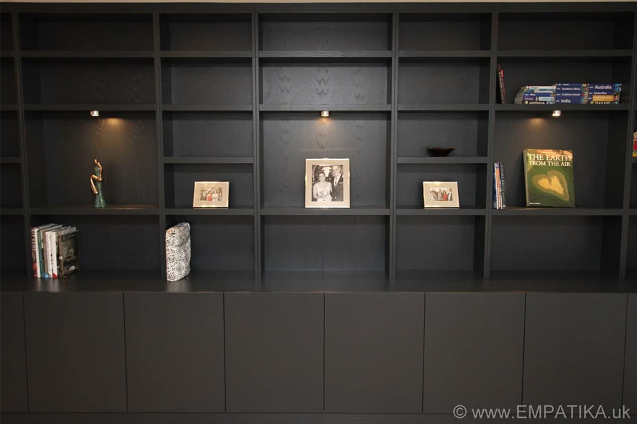 Bespoke built in floor to ceiling display unit painted Black with accent LED lights highlight 3 large shelves
