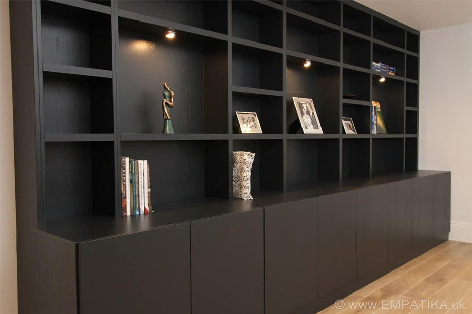 Large home display unit painted Black with ceiling high shelving, ambient LED lights, and bottom cabinets