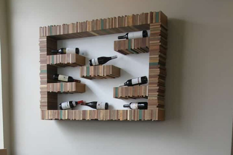 Interiors of a restaurant with bespoke floating display unit with wine shelves made from eco-friendly Milo wood