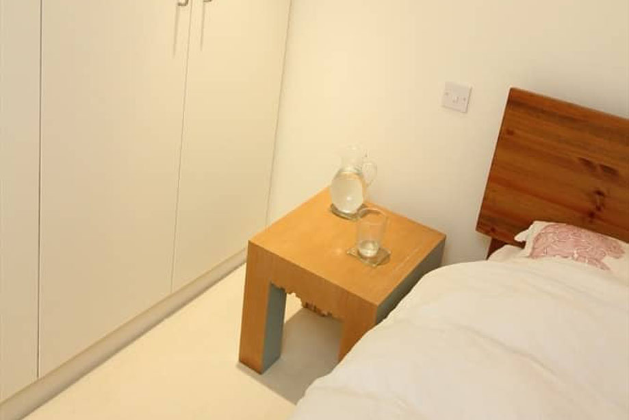 Eco-friendly recycled wood beside table inside a bedroom