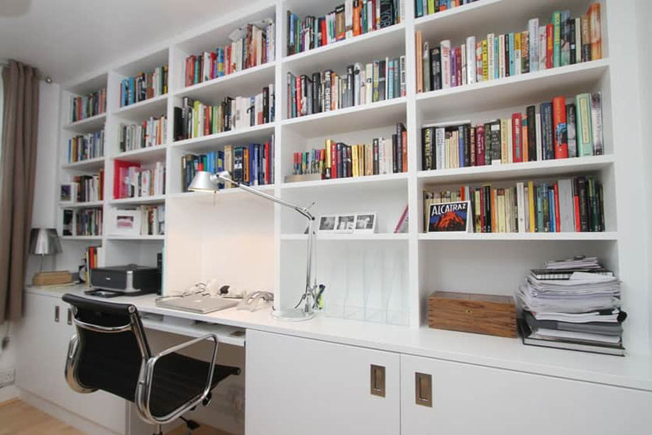 Floor to ceiling library bookcase with pull-out computer desk and bottom cabinets with steel pocket door handles