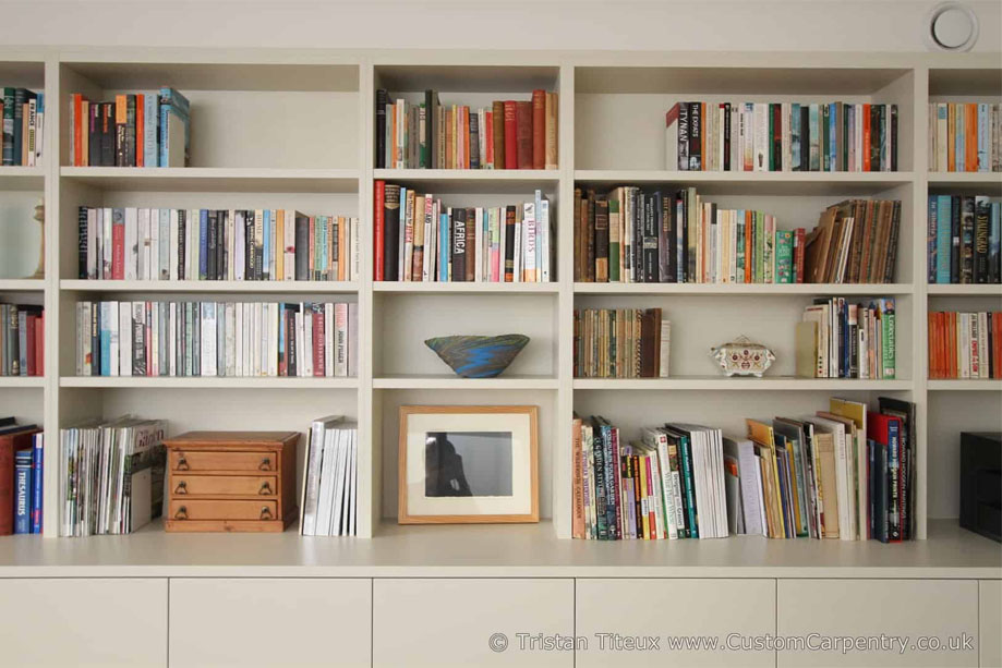 Sleek library bookcase with desk and bottom closets all painted White