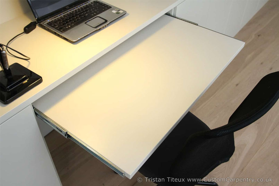 Close up photo of custom library bookcase with melamine coated white painted keyboard tray
