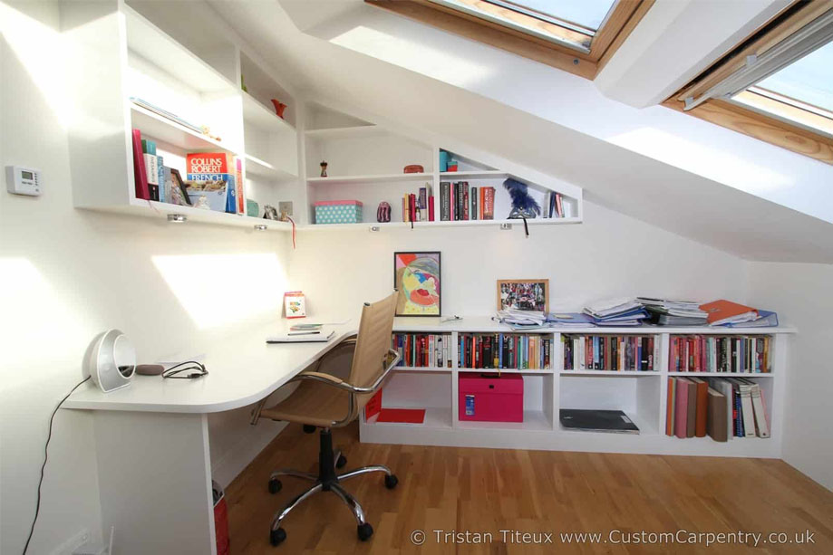Custom made White painted desk with open shelving built on two walls in an attic