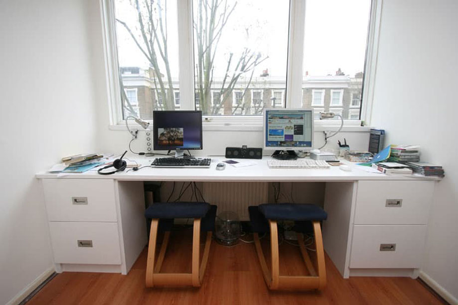 Full view of custom White painted home office desk with drawers bottom drawers on the ends
