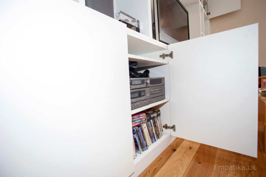Fitted TV media unit with closets and spacious shelves inside all painted White