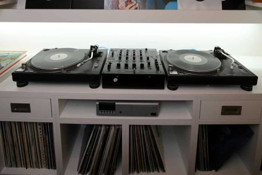 Custom built in media unit with LED panel on main shelf and several square record shelves