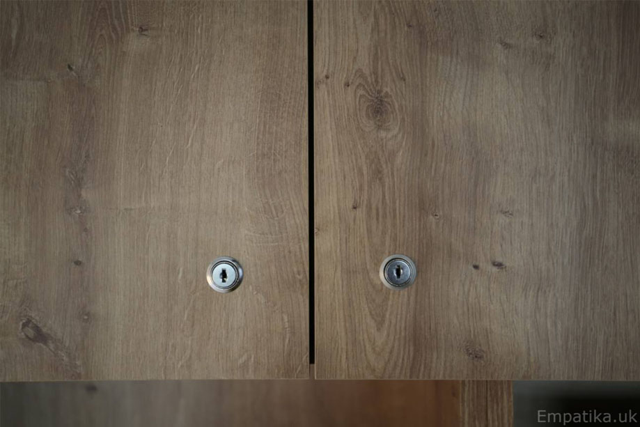 Closer view of bespoke TV media unit with lock and key cupboards