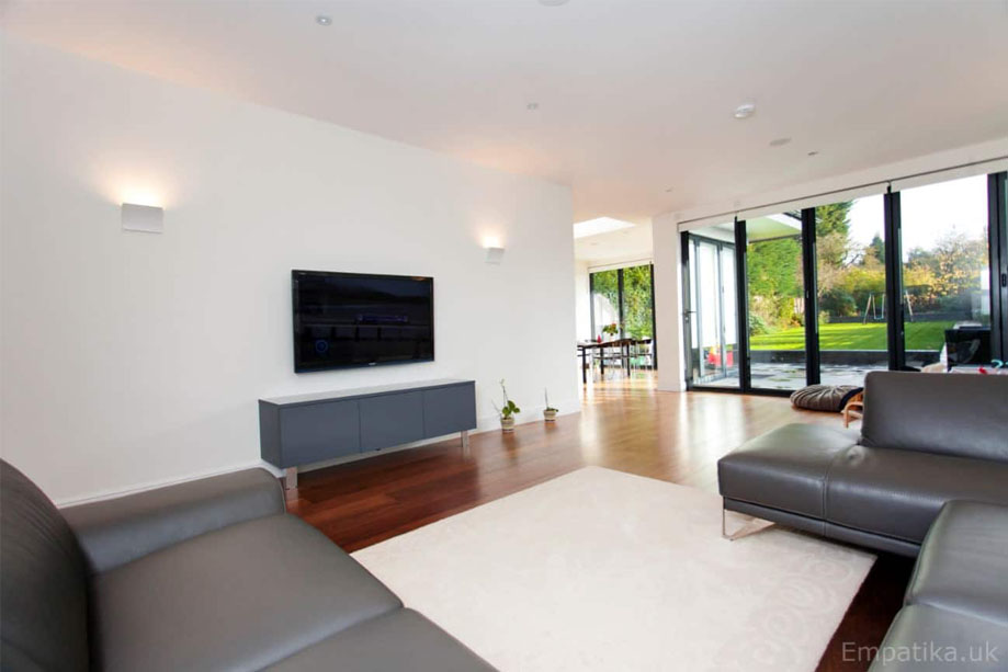 View of spacious living room with custom built-in media unit spraypainted Gray with steel legs