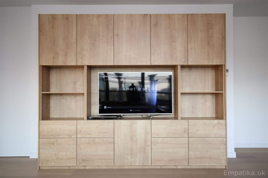 Full view of bespoke built in TV media unit with top and bottom cupboards in prefinished melamine coated wood