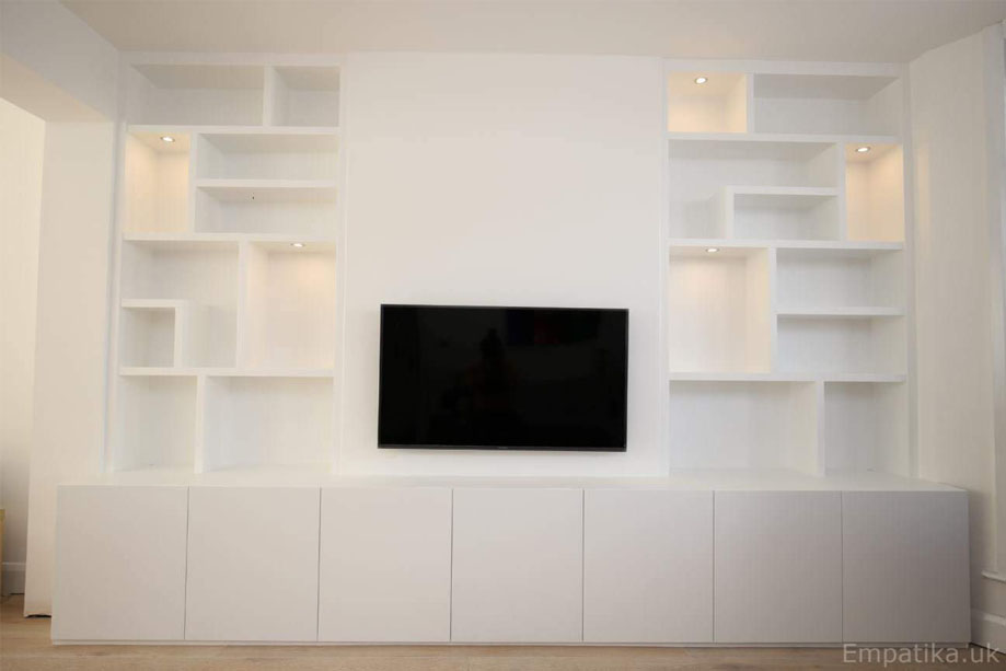 Low media unit with 2 alcove library bookcases ceiling high shelves and a wall-mounted TV in between