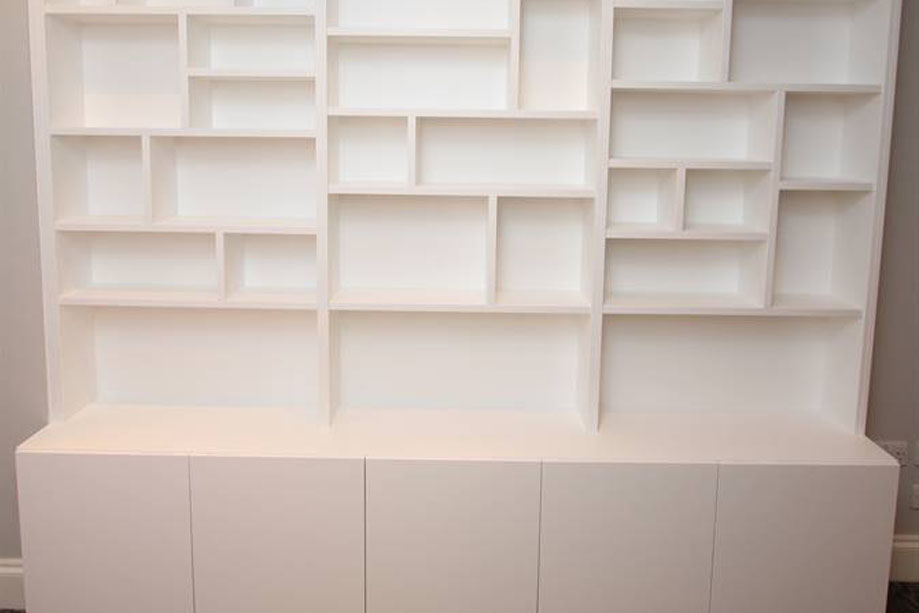 Fitted storage shelves hand painted white in London