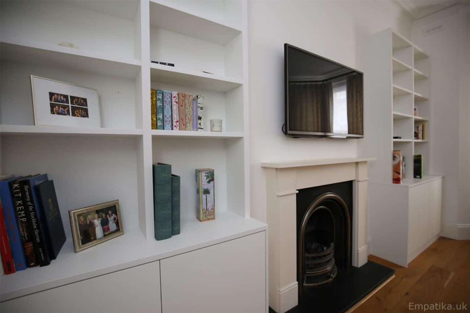 Custom White painted living room alcove cupboards with open shelving and 2 bottom closets without handles