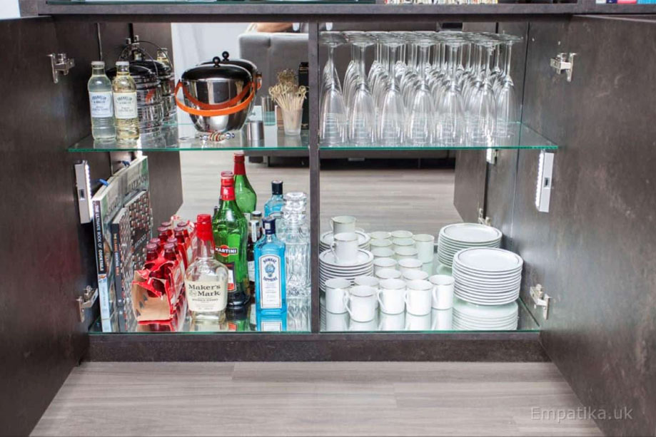 Closer look at display unit bottom wine closet with glass shelving and mirror back wall